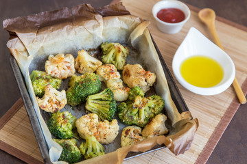 Baked broccoli and cauliflower with spices on parchment paper. Vegan healthy diet dish