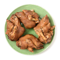 sauced pig's feet. on white background.