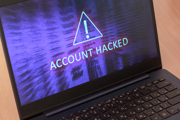 Text account hacked on laptop screen. Warning triangular sign with exclamation mark symbol. Blue...