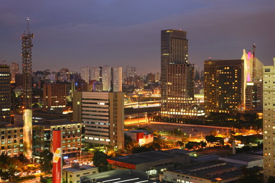 Sao Paulo city skyline with Octavio Frias de Oliveira Bridge and Morumbi district during night, Brazil