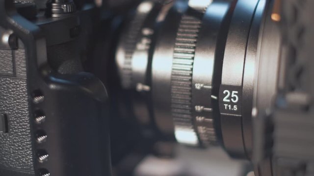 Professional digital cinema camera with a manual lens, closeup.