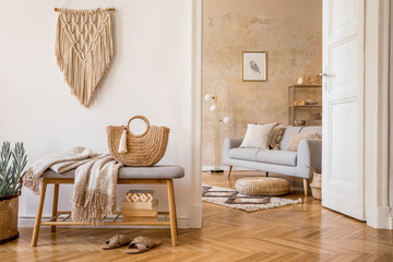 Scandinavian interior of open space with wooden bench, grey sofa, pillows, palid, mock up picture...