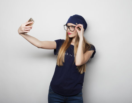 Pretty young woman taking selfie.
