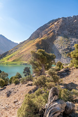 The Pamir range view and peaceful campsite on Kulikalon lake in Fann mountains in Tajikistan. Amasing colorful reflection in pure ice lake.