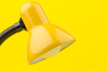 Yellow desk lamp isolated on yellow  background