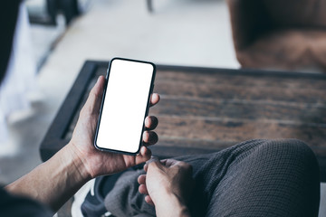 cell phone Mockup image blank white screen.man hand holding texting using mobile on desk at coffee shop.background empty space for advertise.work people contact marketing business,technology