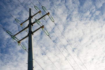 Pillar and power lines against a cloudy sky 3
