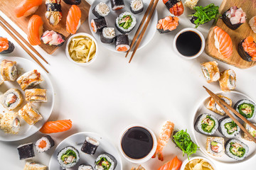 Japanese food. Big sushi set. Assorted set of various sashimi, maki and sushi rolls with different fillings - tuna, sea bass, salmon, shrimp, vegetables. Flatlay copy space © ricka_kinamoto
