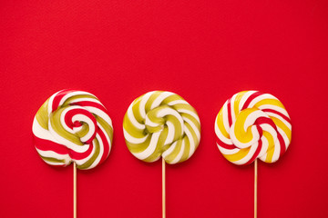 Sweet colorful lolly pops on red