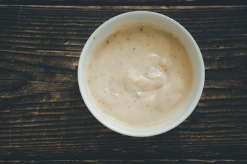 Caesar salad cream in a white bowl