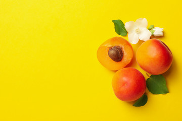 Fresh tasty apricots on yellow background, top view