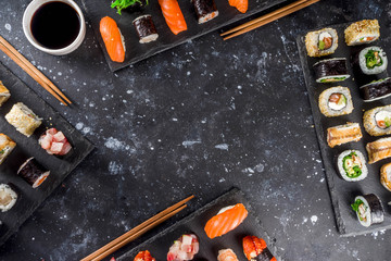 Japanese food. Big sushi set. Assorted set of various sashimi, maki and sushi rolls with different fillings - tuna, sea bass, salmon, shrimp, vegetables. Flatlay copy space © ricka_kinamoto