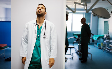 Surgeon, doctor man after an operation. Tired, overworked, people, hospital concept.
