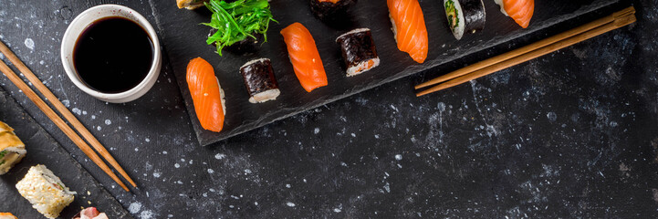 Japanese food. Big sushi set. Assorted set of various sashimi, maki and sushi rolls with different fillings - tuna, sea bass, salmon, shrimp, vegetables. Flatlay copy space © ricka_kinamoto