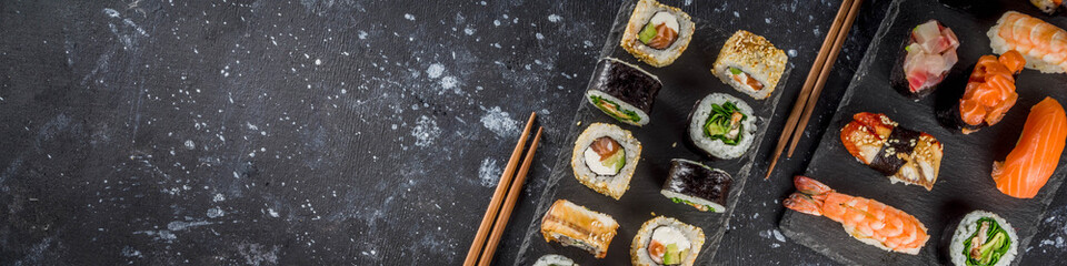 Japanese food. Big sushi set. Assorted set of various sashimi, maki and sushi rolls with different fillings - tuna, sea bass, salmon, shrimp, vegetables. Flatlay copy space