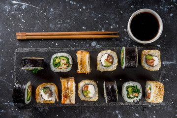 Japanese food. Big sushi set. Assorted set of various sashimi, maki and sushi rolls with different fillings - tuna, sea bass, salmon, shrimp, vegetables. Flatlay copy space