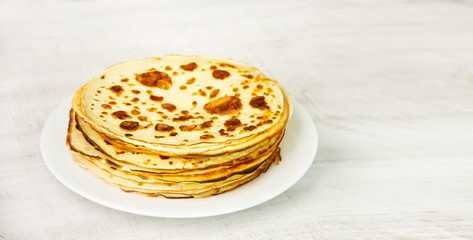 A stack of pancakes on a wooden table
