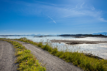 FINNOY, NORWAY - 2014 JUNE 02. Smal road close to the ocean in the summertime in Norway.