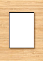 Black picture frame hanging on a light wooden wall