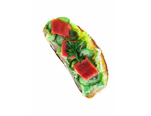 Large toast of rye bread with cheese, cabbage, parsley, fresh cucumber and red fish salmon on white isolated background.