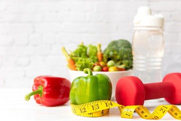 Diet Health food and lifestyle health concept. Sport exercise equipment workout and gym background with fresh salad and measuring tap for fitness style stay at home. Healthy Lifestyle Concept