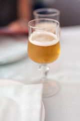 Close up of glass of beer isolated on white background.