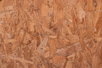 The brown particle board texture was shot close-up. There is a place for text.