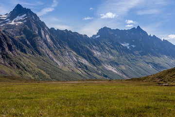 ROMEDALEN, NORWAY - 2014 JULY 21. Dreamy mountain valley with green forests, rocks and snow on top...