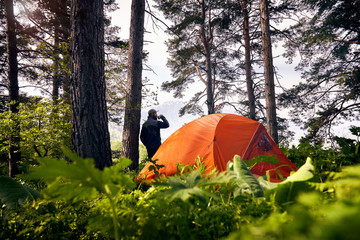 Hiker near the tent outdoor