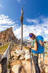 Backpacker woman tourist standing Forcella Cier mountain pass Italy - obrazy, fototapety, plakaty