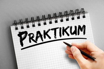 Text note - Praktikum (Internship in German), business concept on notepad