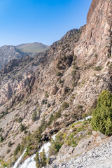 The beautiful mountain trekking road with clear blue sky and rocky hills in Fann mountains in Tajikistan