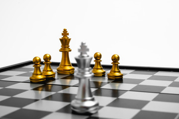 Golden chess team stand against the silver. Focus on golden king and team for Team concept.