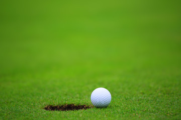 Golf ball close to hole