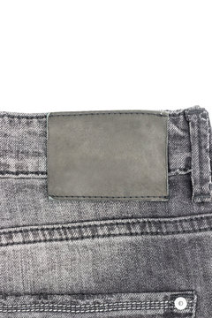 Blank leather jeans label sewed on a black jeans