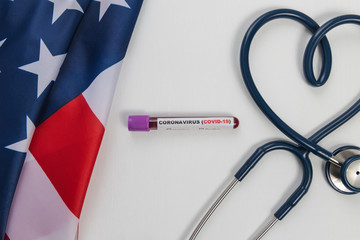 Testing patient’s blood samples for presence of coronavirus (COVID-19) and Stethoscope with Heart symbol and America flag