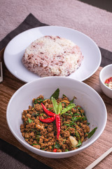 Stir fried minced pork with basil served with steamed jasmin rice and Riceberry, Pad kra pao.