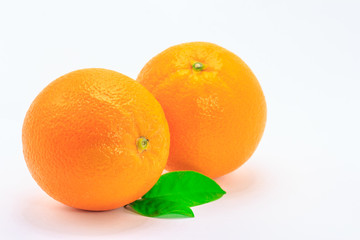 Fresh orange fruit with leaf on white background
