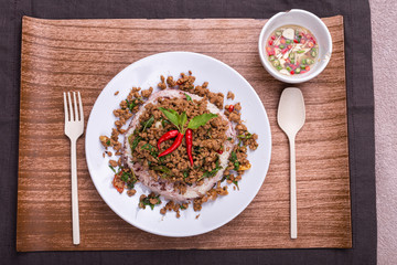 Stir fried minced pork with basil served with steamed jasmin rice and Riceberry, Pad kra pao.