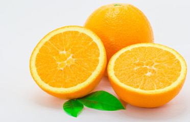 One orange fruit and half cut orange on white background
