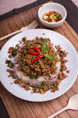 Stir fried minced pork with basil served with steamed jasmin rice and Riceberry, Pad kra pao.