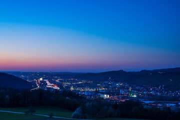 Germany, Day to night sunset and dawning over skyline of houses stuttgart in neckar valley from above