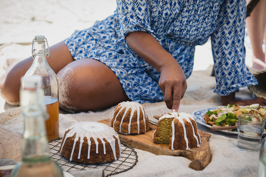 Femme assise en train de d&eacute;couper des g&acirc;teau