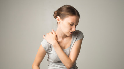 Fototapeta premium Tired woman feeling neck pain, massaging tense muscles
