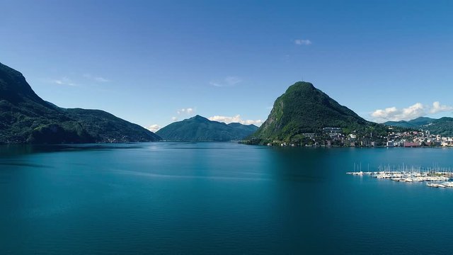 Aerial drone view over Lugano lake in the summer