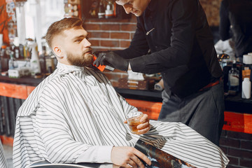 Man with a beard. Hairdresser with a client.