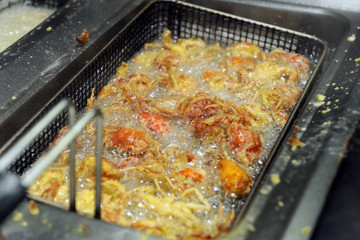 cooking typical Venetian little crabs called Moleche in fried oil