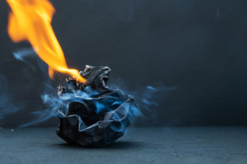 Crumpled paper ball burns with fire