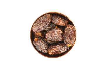 Close-up dates in a bowl isolated on white background.