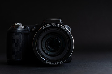 Photo camera in dark backgrond